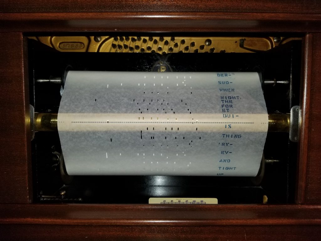 A player piano roll being played, the predecessor of the QRS Music system